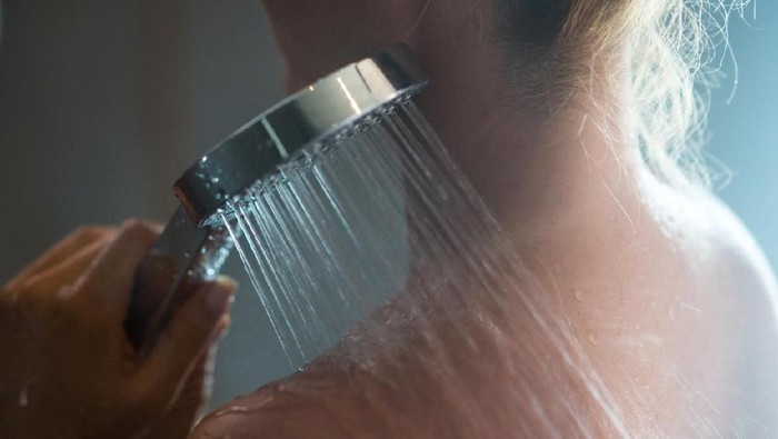 shower mandi Close up of unrecognizable woman under the shower in the morning.