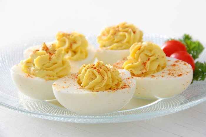 Deviled Egg A plate of deviled eggs, sprinkled with paprika.