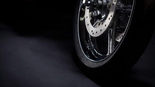 Color shot of a motorcycle forks and tire.