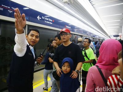 Potret Petugas Bantu Warga yang Antusias Naik MRT