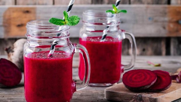 healthy detox beet smoothie with chia seeds in a mason jar on a wooden background