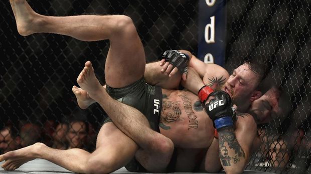 LAS VEGAS, NV - OCTOBER 06: Khabib Nurmagomedov of Russia holds down Conor McGregor of Ireland in their UFC lightweight championship bout during the UFC 229 event inside T-Mobile Arena on October 6, 2018 in Las Vegas, Nevada. Harry How/Getty Images/AFP