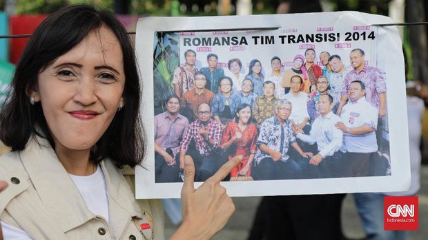 Seorang peserta aksi menunjukkan posisi dirinya dalam foto Tim Transisi.
