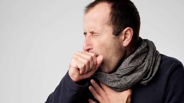 Mature man in scarf is ill from colds or pneumonia. Suffering from flu virus.