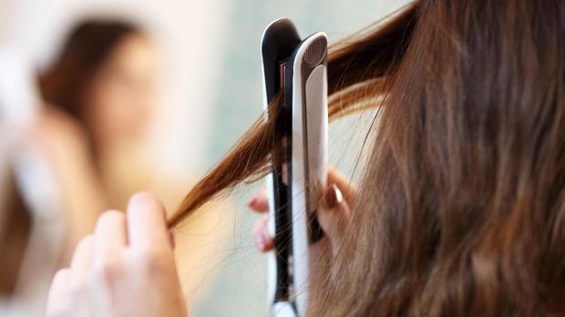 Picture showing young woman looking in bathroom mirror