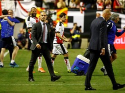 Pelatih Rayo berjalan di dekat Zinedine Zidane yang tertunduk lesu. REUTERS/Javier Barbancho.