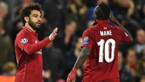 Liverpool's Egyptian midfielder Mohamed Salah (L) celebrates with Liverpool's Senegalese striker Sadio Mane after scoring their second goal during the UEFA Champions League group C football match between Liverpool and Red Star Belgrade at Anfield in Liverpool, north west England on October 24, 2018. (Photo by Oli SCARFF / AFP)