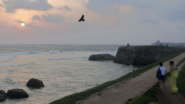 In this Friday, May 10, 2019, photo, foreign tourists walk on the rampart of the 17th century built Dutch fort in Galle, Sri Lanka. Sri Lanka was the Lonely Planet guide’s top travel destination for 2019, but since the Easter Sunday attacks on churches and luxury hotels, foreign tourists have fled. More than 250 people, including 45 foreigners who are mostly from China, India, the U.S. and the U.K., died in the series of suicide bombings by Islamic State and its local affiliates in churches and hotels in the capital, Colombo, and across the country on April 21. (AP Photo/Eranga Jayawardena)