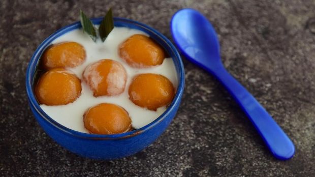 Indonesian cuisine Biji Salak or Candil: porridge of sweet potato balls mixed with tapioca flour cooked in palm sugar sauce served coconut milk. Popular dessert during Ramadhan