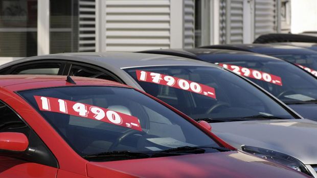 Row of used car with prices.