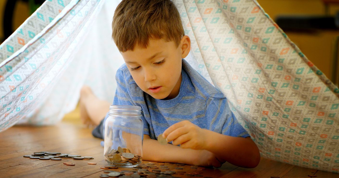 Little girl with piggy bank. Responsible investing concept.