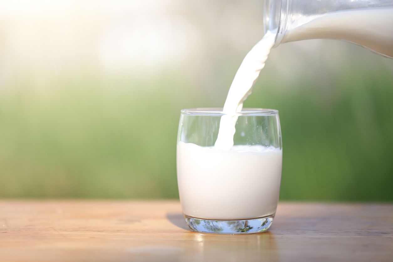 Latin man drinking milk and looking at the camera
