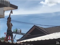 Usai Makan di Tengah Hujan, Pria Ini Lanjut Minum di Atas Genteng!