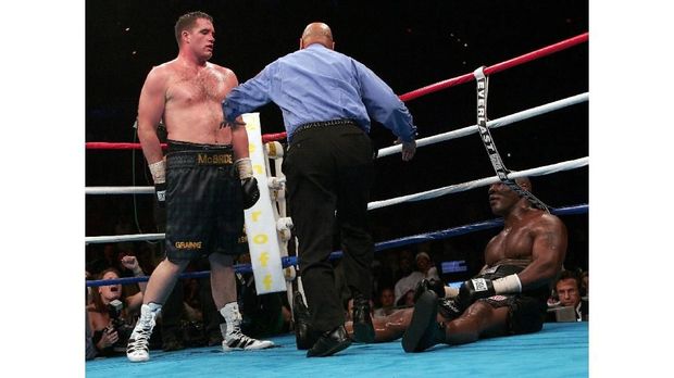 Former heavyweight champion Mike Tyson (R) lies on the canvas after being pushed by Kevin McBride (L) of Ireland  11 June 2005 at the MCI Center in Washington, DC. Tyson learned the hard way that he no longer has the heart for boxing, taking a beating fromMcBride before quitting after six rounds in what he called his ring farewell.     AFP PHOTO/Paul J. RICHARDS (Photo by PAUL J. RICHARDS / AFP)