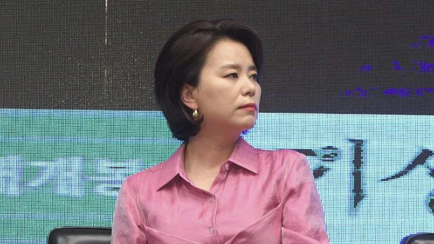 South Korean director Bong Joon-ho (R) speaks as actress Jang Hye-jin (C) and Park So-dam (L) listen to during a press conference for their film 