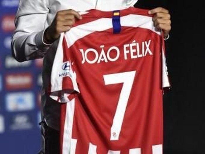 Atletico Madrid's new Portuguese midfielder Joao Felix holds his new jersey during his official presentation at the Wanda Metropolitan stadium in Madrid on July 8, 2019. (Photo by PIERRE-PHILIPPE MARCOU / AFP)