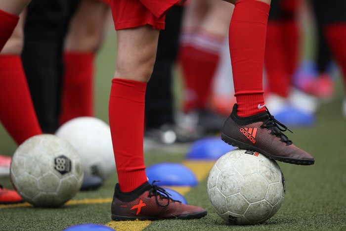 BERLIN, GERMANY - JUNE 13:  Girls line up with soccer balls while participating in a training day in a program to encourage integration of children with foreign roots through football at the SV Rot-Weiss Viktoria Mitte 08 sport club shortly before the arrival of German Chancellor Angela Merkel on a visit on June 13, 2018 in Berlin, Germany. Merkel is hosting an intergration summit at the Chancellery later today.  (Photo by Sean Gallup/Getty Images)