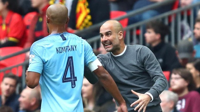 LONDON, ENGLAND - MAY 18: Josep Guardiola, Manager of Manchester City talks to Vincent Kompany of Manchester City during the FA Cup Final match between Manchester City and Watford at Wembley Stadium on May 18, 2019 in London, England. (Photo by Julian Finney/Getty Images)