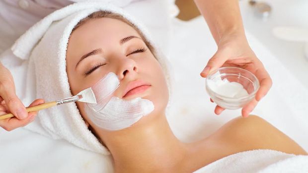 Woman in mask on face in spa beauty salon.