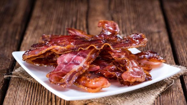 Fried Bacon (selective focus) on an old vintage wooden table