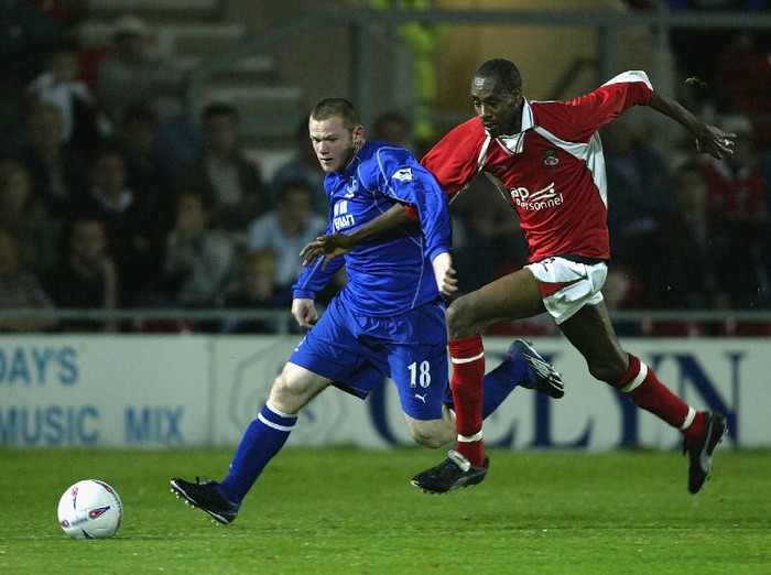 WREXHAM - OCTOBER 1:  Wayne Rooney of Everton beats Dennis Lawrence of Wrexham during the Worthington Cup second round match between Wrexham and Everton at the Racecourse Ground, Wrexham on October 1, 2002. (Photo by Alex Livesey/Getty Images)