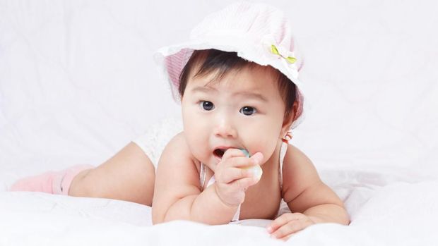 close up asian adorable baby, new born children toddler on soft textile bed