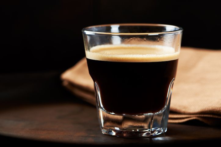 Coffee cup and beans on wooden table. Top view.