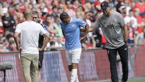 Liverpool's manager Jurgen Klopp, right, pats Manchester City's Leroy Sane as he leaves the pitch after an injury, during the English Community Shield soccer match between Liverpool and Manchester City at Wembley stadium in London, Sunday, Aug. 4, 2019. (AP Photo/Kirsty Wigglesworth)