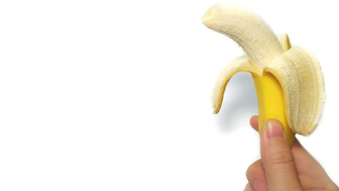 ilustrasi penis yellow banana and the hand in the white background