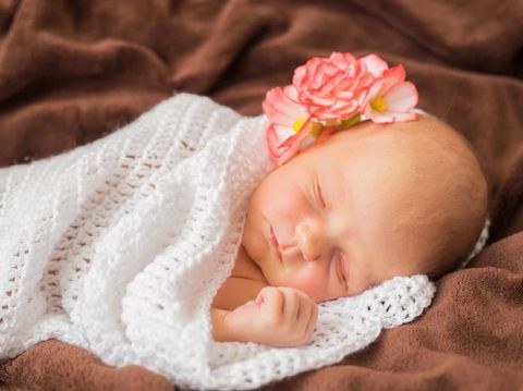 Newborn baby with flower sleeping