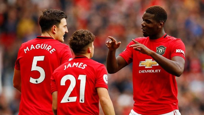 Manchester United Soccer Football - Premier League - Manchester United v Chelsea - Old Trafford, Manchester, Britain - August 11, 2019 Manchester United's Daniel James celebrates scoring their fourth goal with Harry Maguire and Paul Pogba Action Images via Reuters/Jason Cairnduff EDITORIAL USE ONLY. No use with unauthorized audio, video, data, fixture lists, club/league logos or