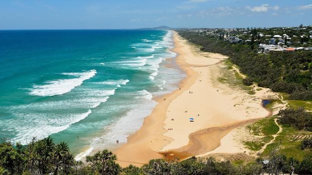 View over Sunshine Beach south of Noosa, QLD, with people.