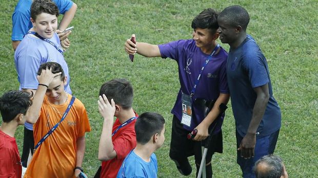 Kante (kanan) meladeni fan selfie bersamanya. (
