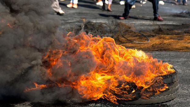 Protesters against the government burning rubber tyres in the streets in South Africa