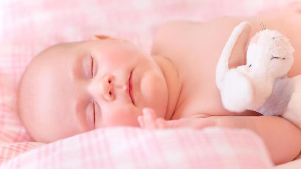 Sweet kid sleeps, relaxing in the bed, adorable healthy child dreaming, happy life concept