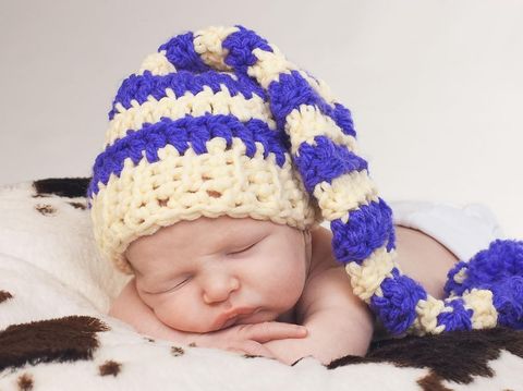 Sweet newborn baby boy in hat is sleeping