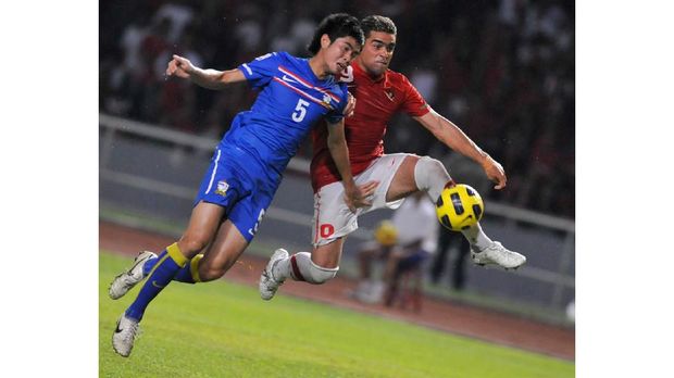 Indonesia's Cristian Gonzales (R) attempts for a goal against Thailand's Suttinun Phukhom (L) during their AFF Suzuki Cup 2010 group A football match in Jakarta on December 7, 2010. Indonesia won 2-1 against Thailand. AFP PHOTO / ROMEO GACAD (Photo by ROMEO GACAD / AFP)