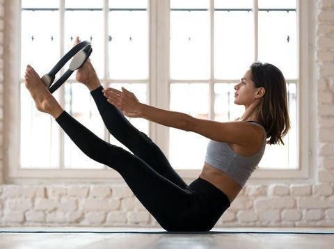 Woman doing squats with a kettlebell