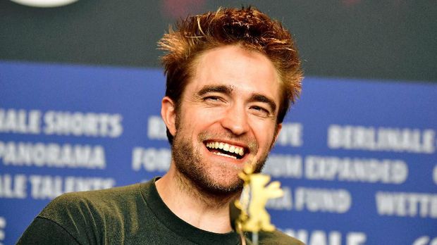 British actor Robert Pattinson laughts during a press conference to present the feminist western 