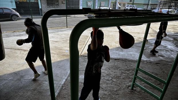 Youth train at the Ramirez Gym in Ecatepec, State of Mexico on May 8, 2019. - Former professional football player and amateur boxer Miguel Angel Ramirez set up a small gym under a vehicular bridge to keep children away from drugs, teach them a sport and prevent them to enlist in the ranks of organized crime. (Photo by ALFREDO ESTRELLA / AFP)