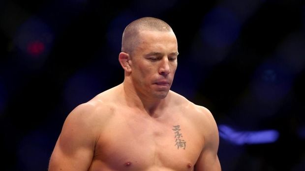 NEW YORK, NY - NOVEMBER 04: Georges St-Pierre of Canada enters the octagon for his UFC middleweight championship bout against Michael Bisping of England during the UFC 217 event at Madison Square Garden on November 4, 2017 in New York City.   Mike Stobe/Getty Images/AFP