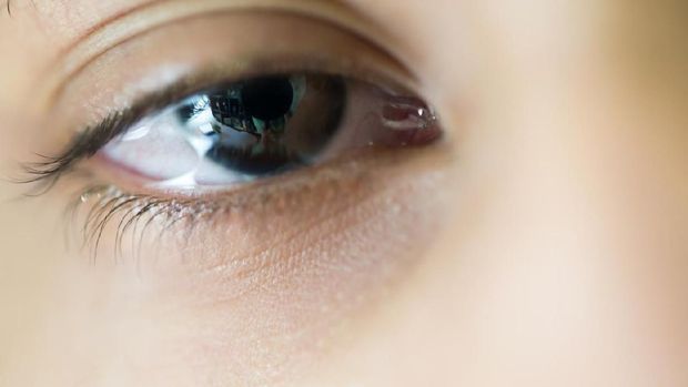 Young boy in tears against bright light, close-up composition.