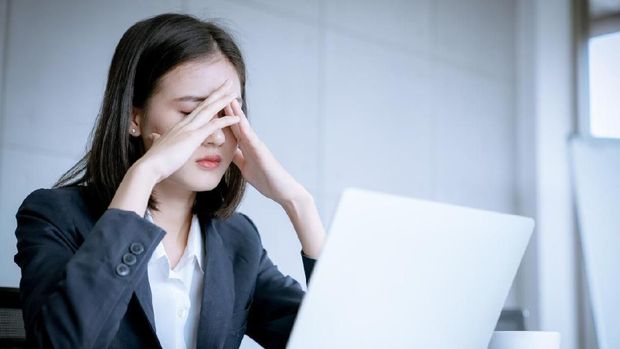 Asian business woman headache stressed because of work mistake problems about profit losses to be risk for fired from her job