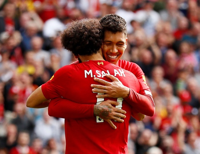 Soccer Football - Premier League - Liverpool v Newcastle United - Anfield, Liverpool, Britain - September 14, 2019  Liverpools Mohamed Salah celebrates scoring their third goal with teammate Roberto Firmino   Action Images via Reuters/Jason Cairnduff  EDITORIAL USE ONLY. No use with unauthorized audio, video, data, fixture lists, club/league logos or 