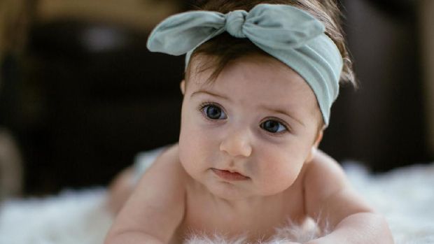 Cute baby girl crawling. Shallow DOF. Developed from RAW; retouched with special care and attention; Small amount of grain added for best final impression. 16 bit Adobe RGB color profile.