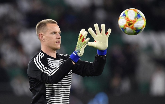 Germanys goalkeeper Marc-Andre ter Stegen catches the ball during a warm-up session prior to the friendly football match Germany v Serbia in Wolfsburg, western Germany on March 20, 2019. (Photo by John MACDOUGALL / AFP)