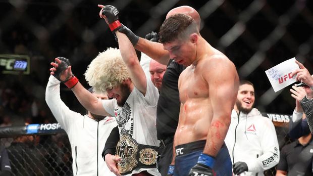 NEW YORK, NY - APRIL 07: Khabib Nurmagomedov (L) celebrates his win over Al Iaquinta (R) to capture the UFC lightweight championship at UFC 223 at Barclays Center on April 7, 2018 in New York City.   Ed Mulholland/Getty Images/AFP