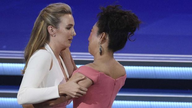 Jodie Comer, left is congratulated by Sandra Oh before she goes on stage to accept the award for outstanding lead actress in a drama series for 