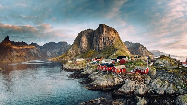 Lofoten Islands, Norway Norwegian fishing village at the Lofoten Islands in Norway. Dramatic sunset clouds moving over steep mountain peaks