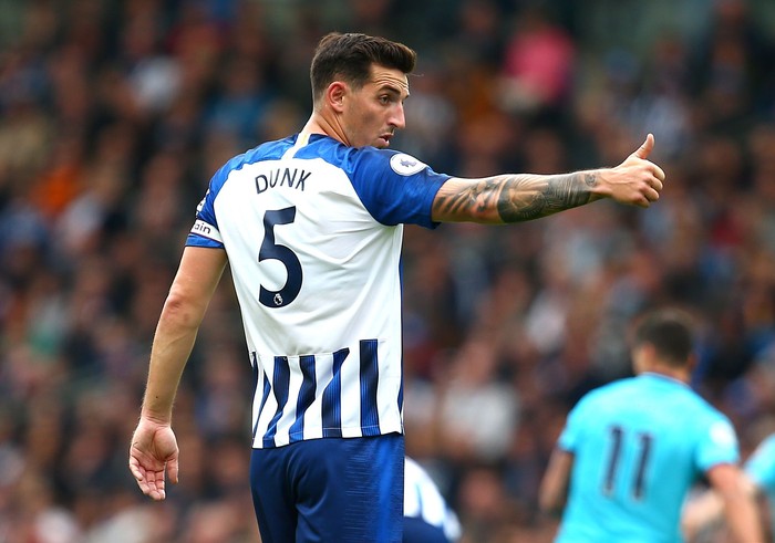 Lewis Dunk BRIGHTON, ENGLAND - OCTOBER 05: Lewis Dunk of Brighton and Hove Albion reacts during the Premier League match between Brighton & Hove Albion and Tottenham Hotspur at American Express Community Stadium on October 05, 2019 in Brighton, United Kingdom. (Photo by Charlie Crowhurst/Getty Images)